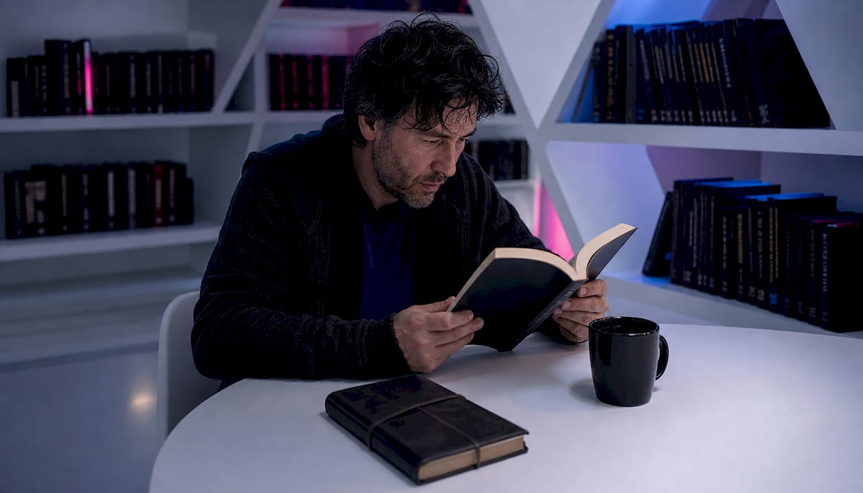 Man reading dark atmospheric novel in café