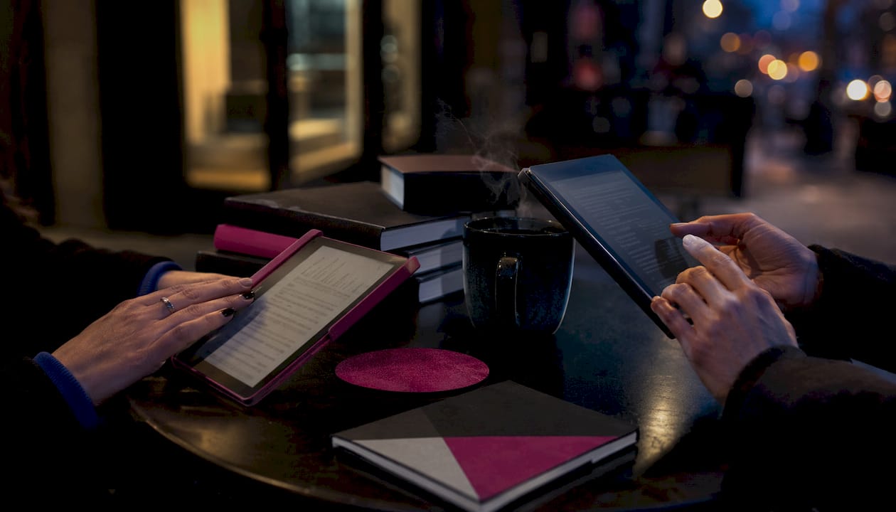 Overhead view of Kindle and tablet comparing ebook apps
