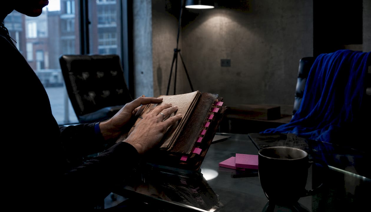 Close-up of hands writing psychological horror notes