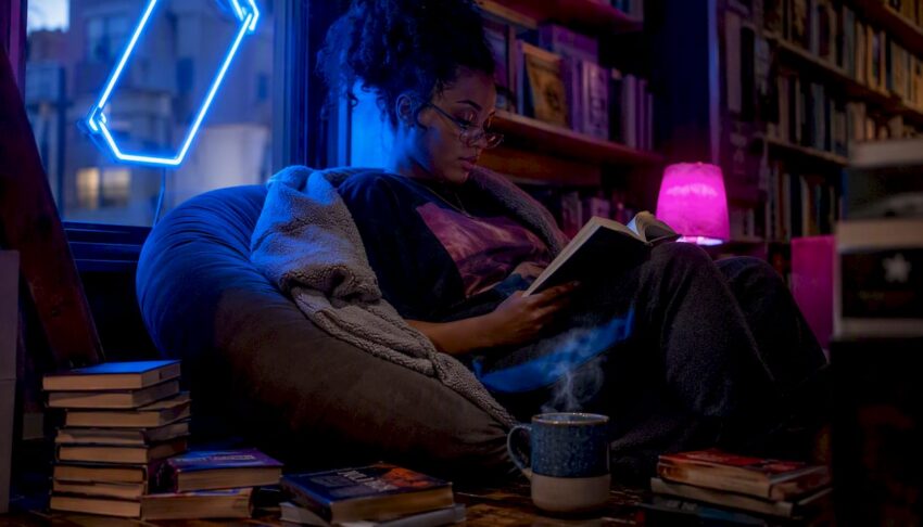 Woman reading cult horror novel in cozy living room