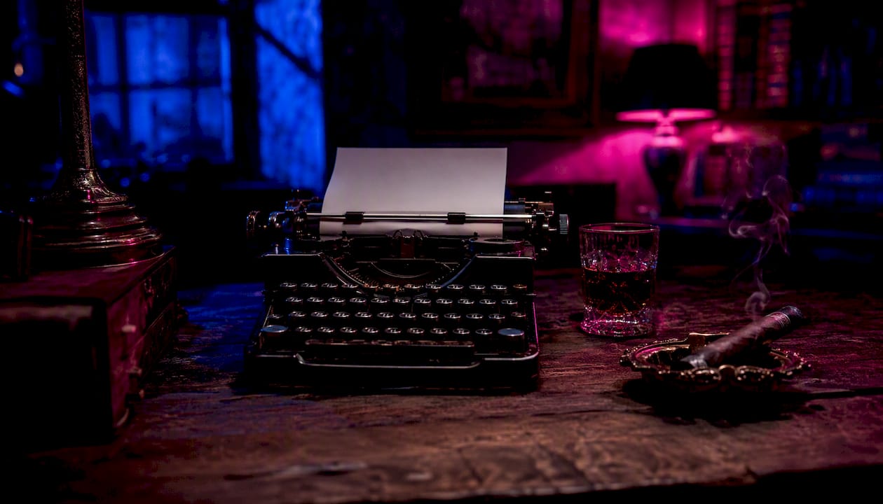 Partial typewriter with drink and ashtray