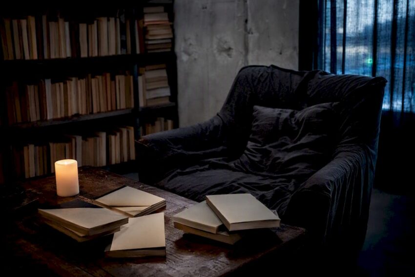 Dim reading nook with blank indie horror books