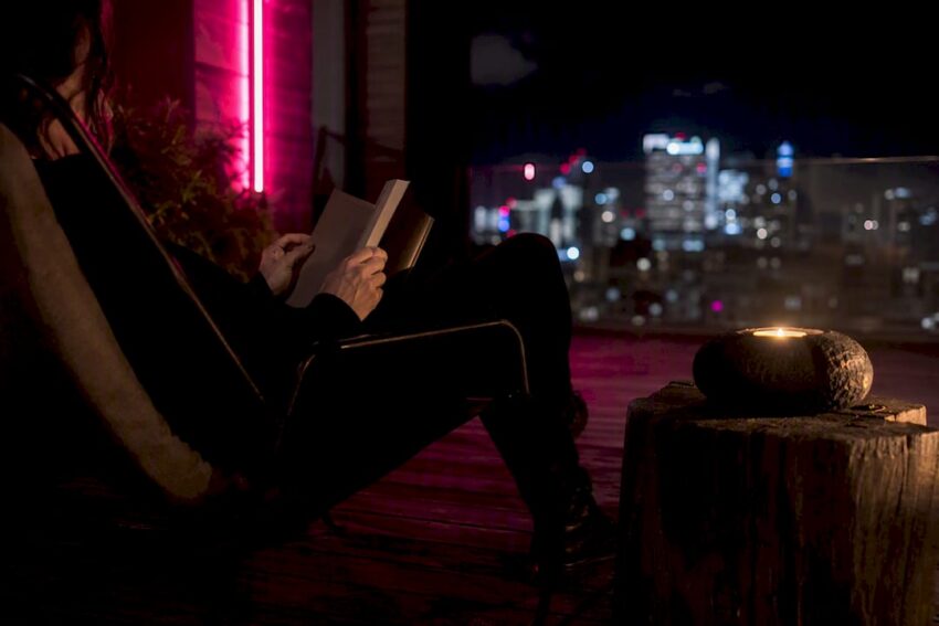 Hands turning pages of dark thriller book