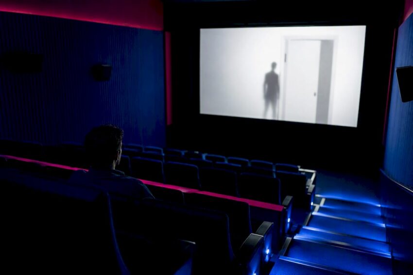 Viewer watching an ambiguous horror film