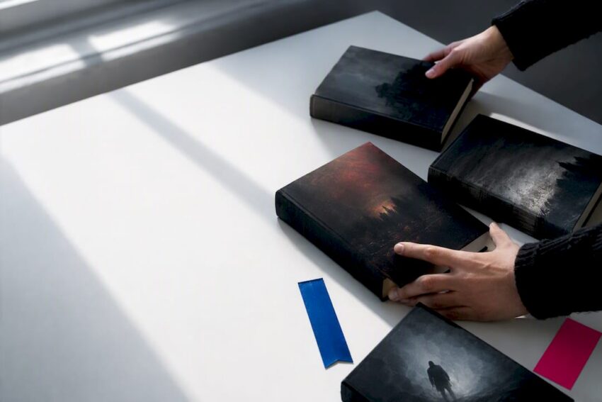 Anonymous books arranged into dark reading routes
