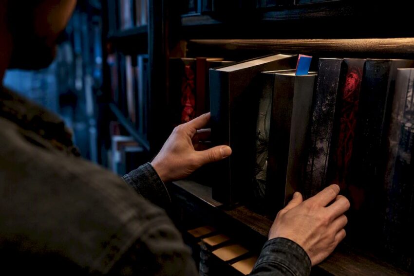 Reader choosing among anonymous horror books
