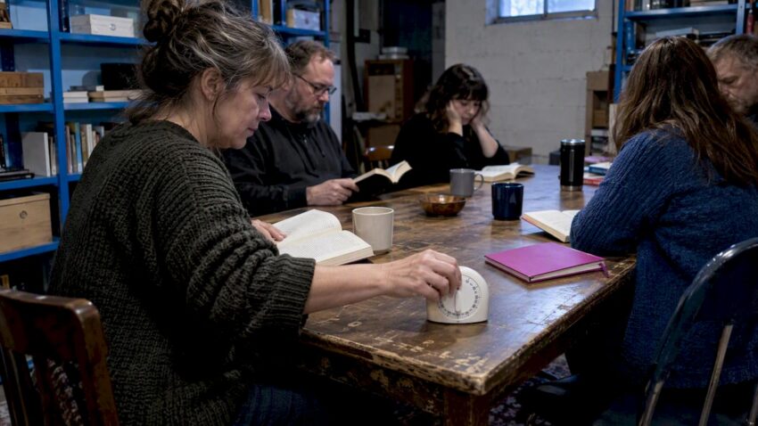 Book club member starting a meeting timer