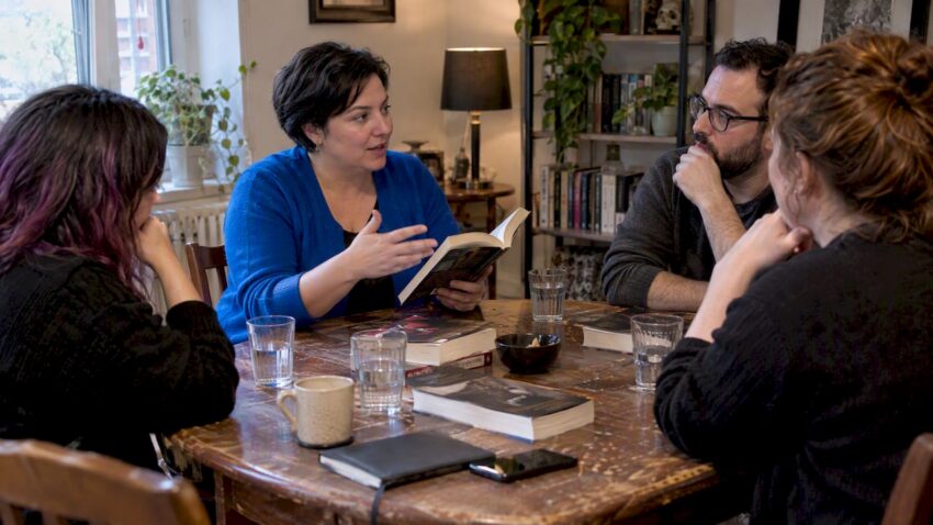 Host guiding a horror book club discussion