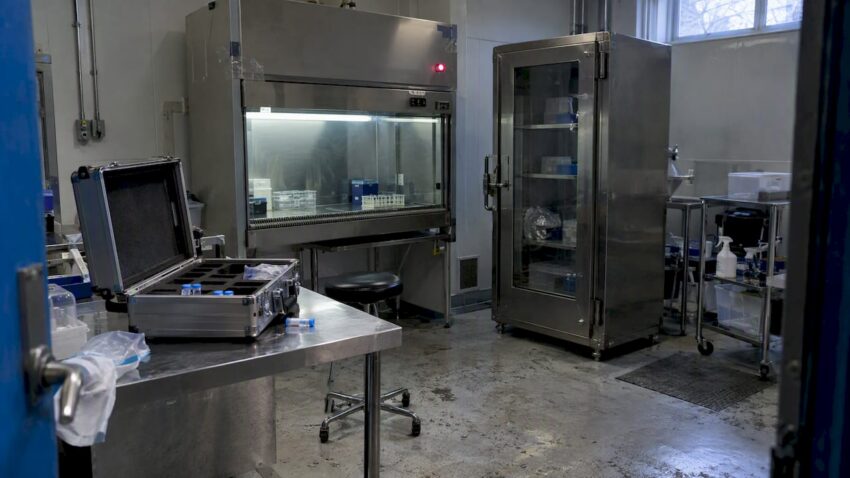 Unlatched sample case in a containment room