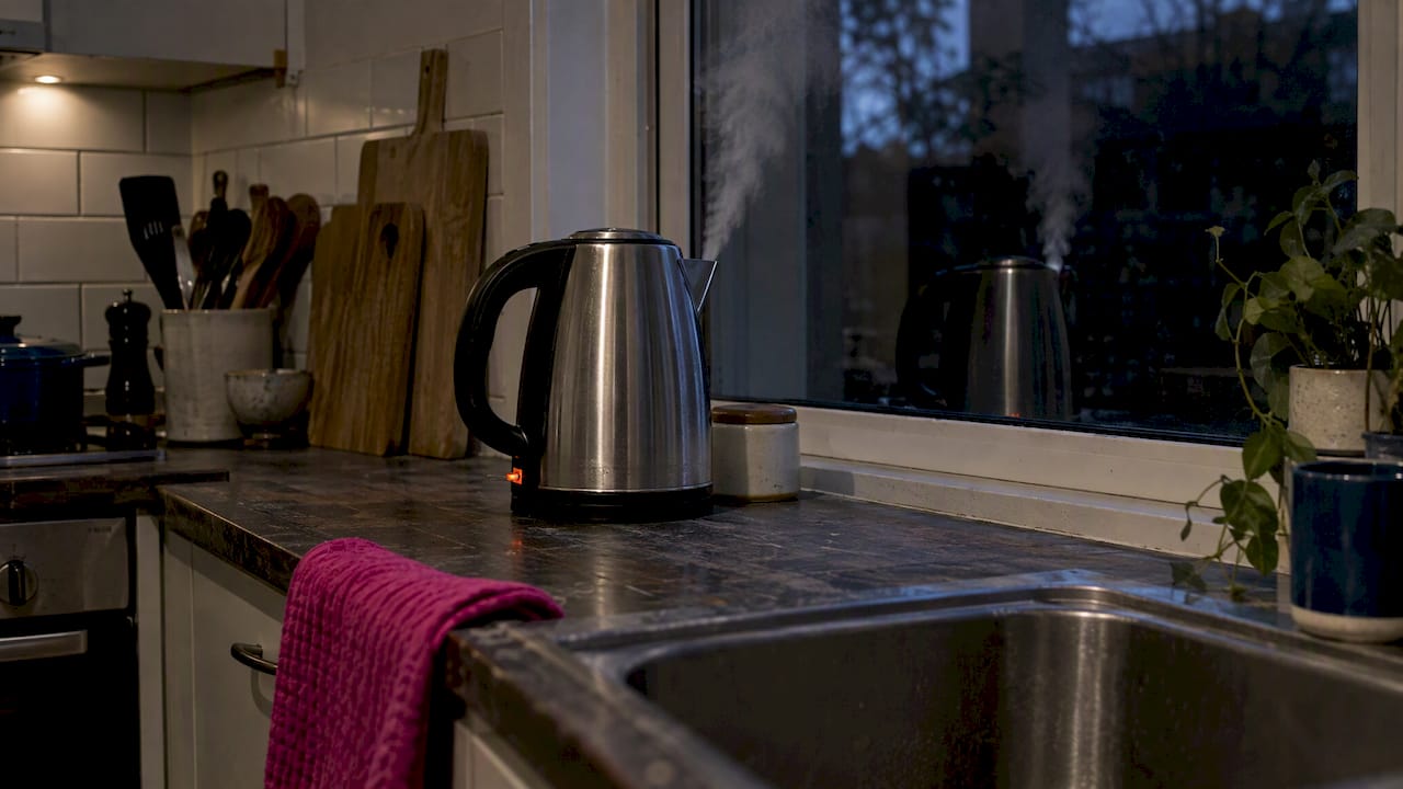 Whistling kettle beside a mismatched reflection
