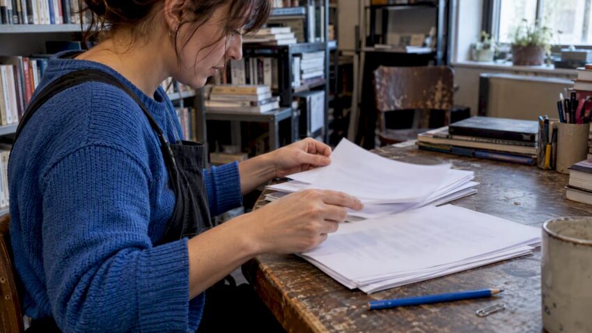 Author comparing short story and screenplay pages