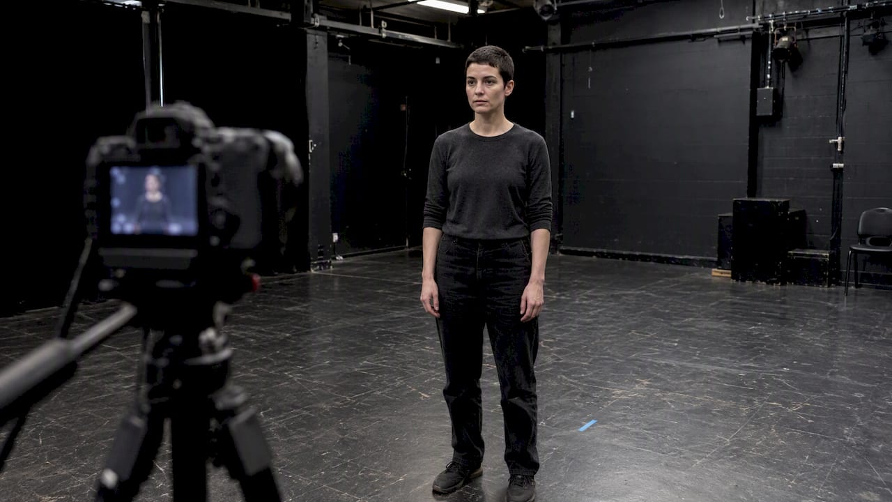 Actor holds a still gaze during horror rehearsal