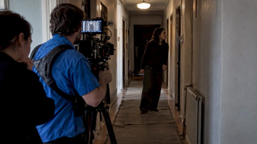 Small crew filming a contained horror scene